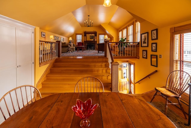 dining room featuring vaulted ceiling and a notable chandelier