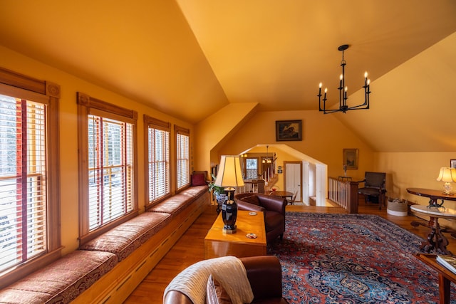 living room with a chandelier, wood-type flooring, and vaulted ceiling