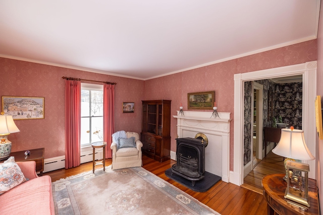 living room featuring hardwood / wood-style floors, a wood stove, and ornamental molding