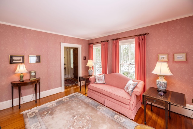 living room featuring hardwood / wood-style flooring, a baseboard radiator, and crown molding