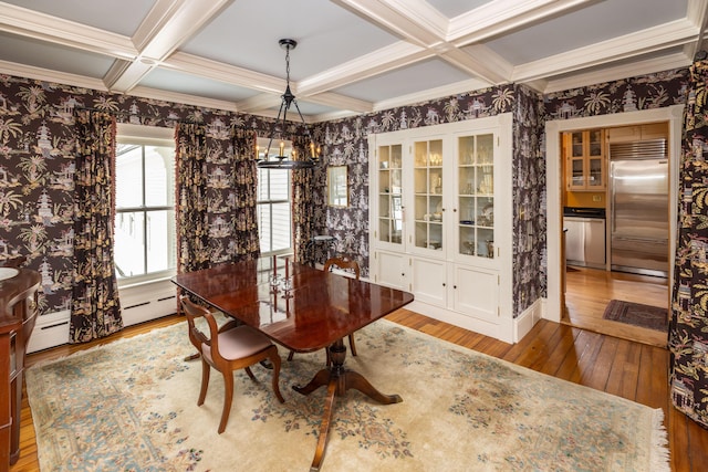 dining area featuring beam ceiling, crown molding, light hardwood / wood-style flooring, and coffered ceiling