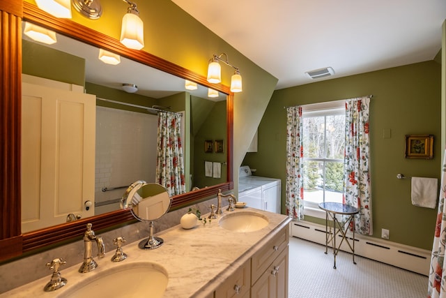 bathroom with baseboard heating, washing machine and dryer, vanity, and walk in shower