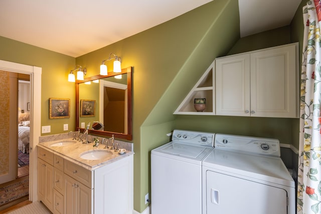 laundry area with sink, light tile patterned floors, and washer and dryer