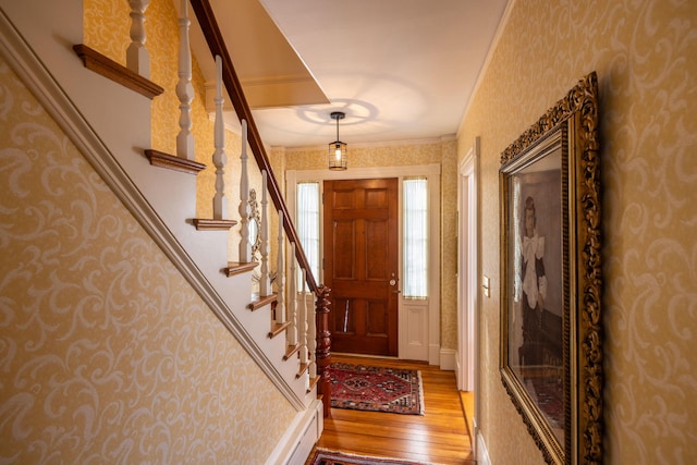 foyer featuring light hardwood / wood-style flooring and ornamental molding