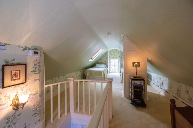 additional living space with light carpet and lofted ceiling with skylight