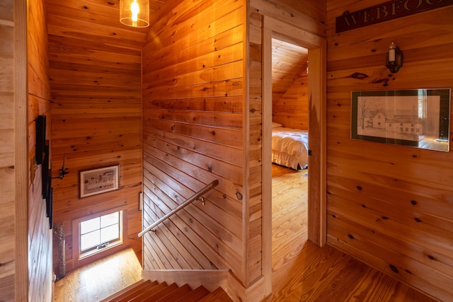 interior space with wooden walls and hardwood / wood-style flooring