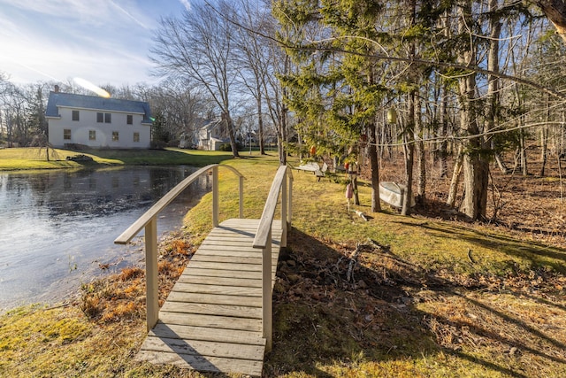 exterior space featuring a lawn and a water view