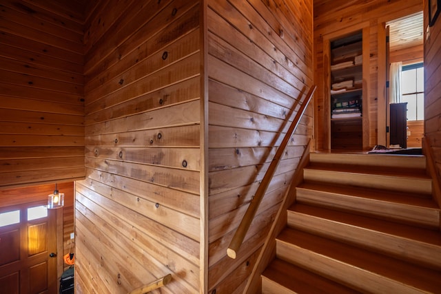 stairs featuring wooden walls