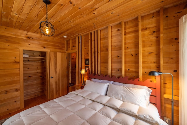 bedroom with wooden walls and wood ceiling