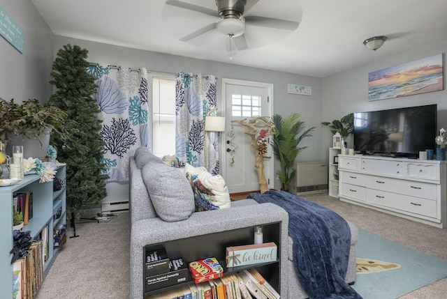 carpeted bedroom featuring ceiling fan and a baseboard heating unit