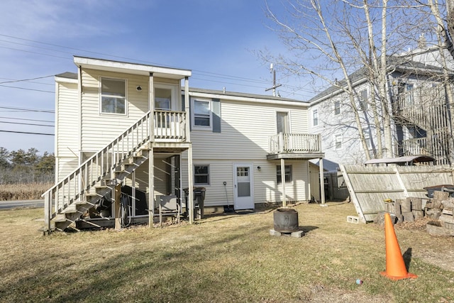 back of house with a yard and a balcony