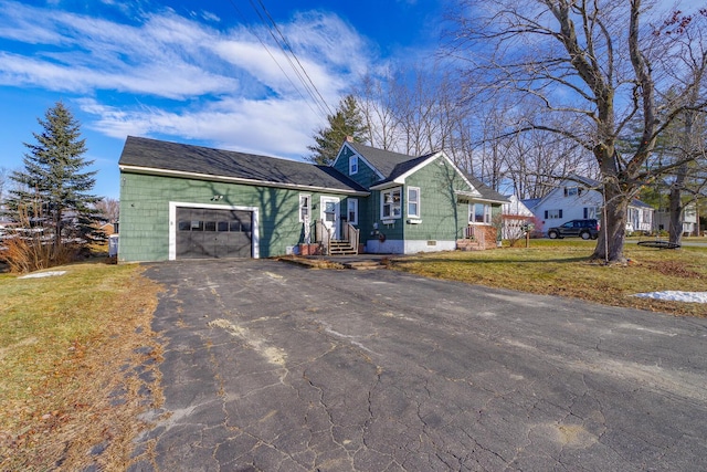 ranch-style house with a front yard and a garage