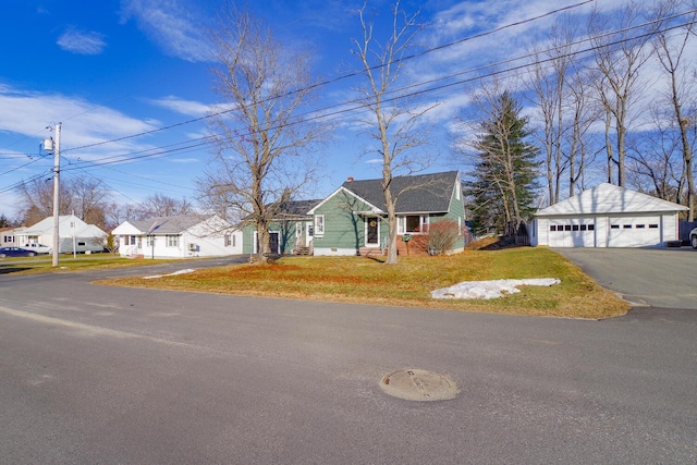 view of front of home with a garage and an outdoor structure