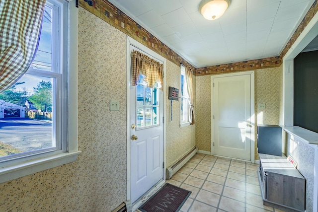 entryway with baseboard heating, crown molding, and light tile patterned flooring