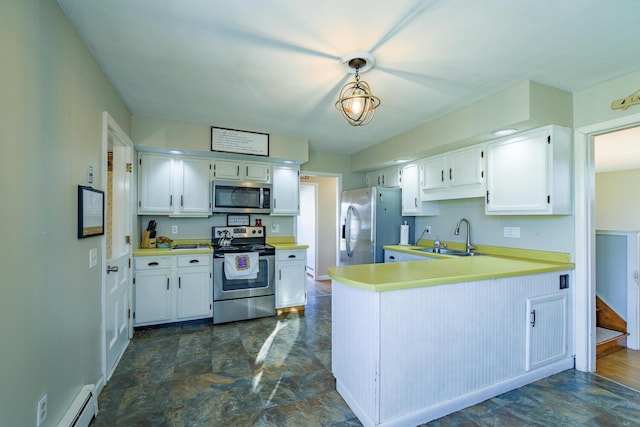 kitchen with sink, white cabinets, stainless steel appliances, and decorative light fixtures