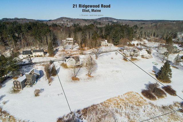 snowy aerial view featuring a mountain view