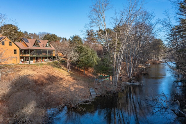 back of property featuring a water view