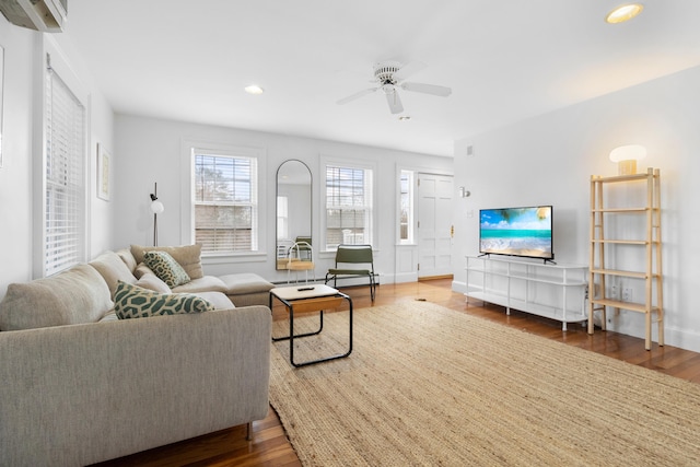 living room with ceiling fan and dark hardwood / wood-style floors