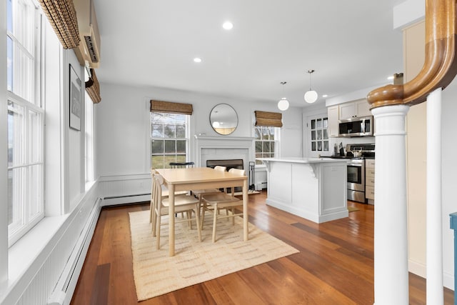 dining area featuring hardwood / wood-style flooring and baseboard heating