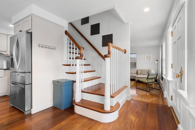 staircase with hardwood / wood-style floors