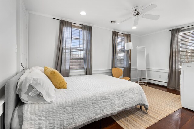 bedroom featuring ceiling fan, dark hardwood / wood-style flooring, crown molding, and a baseboard radiator