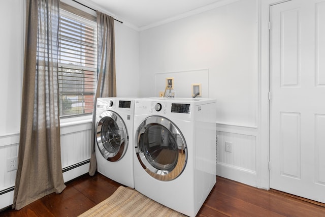 laundry area featuring washer and dryer, ornamental molding, dark wood-type flooring, and a baseboard heating unit