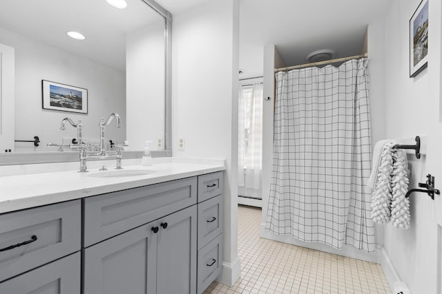 bathroom featuring vanity, a baseboard radiator, and a shower with shower curtain