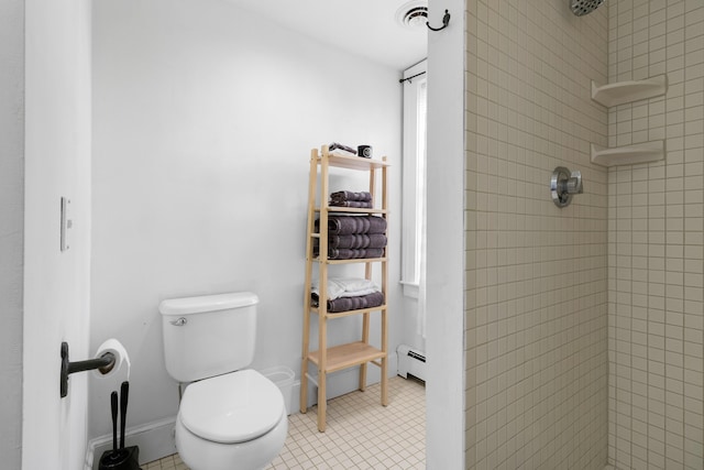 bathroom with tile patterned flooring, toilet, a tile shower, and a baseboard radiator