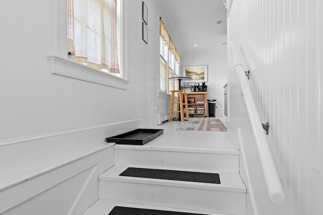 stairs featuring baseboard heating