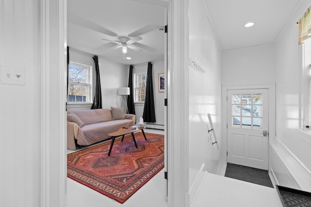 interior space featuring ceiling fan, a baseboard radiator, and ornamental molding