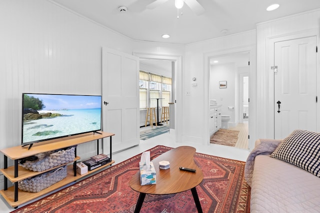 living room with ceiling fan and crown molding