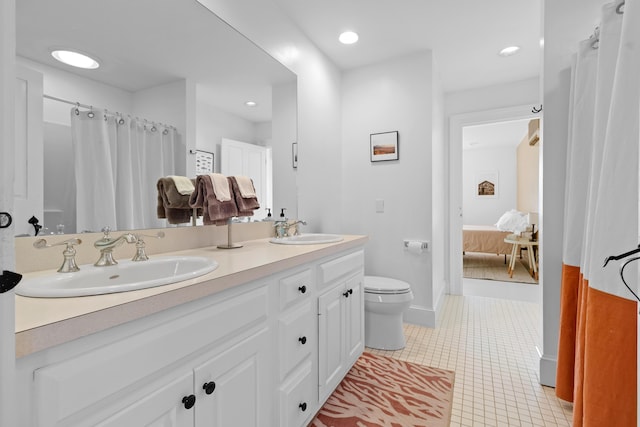 bathroom featuring toilet, vanity, and tile patterned floors