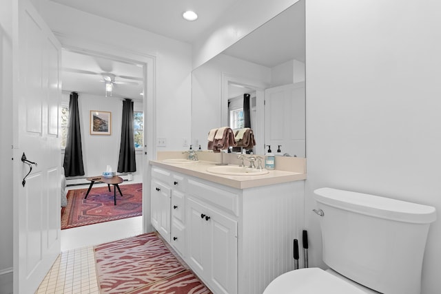 bathroom with vanity, toilet, and ceiling fan