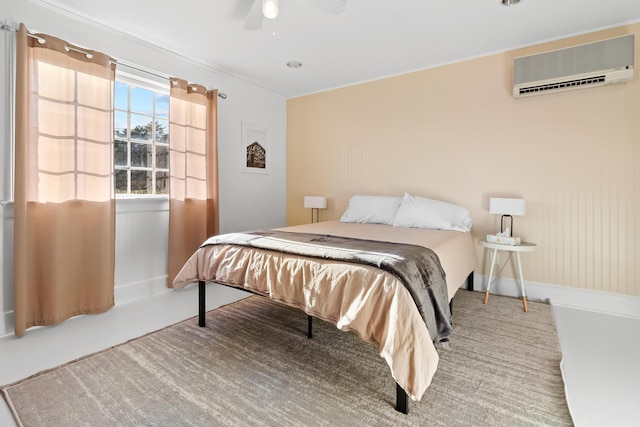 bedroom with an AC wall unit and ceiling fan