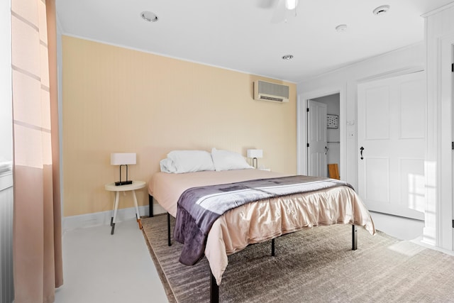 bedroom featuring a wall mounted air conditioner, ceiling fan, and light colored carpet