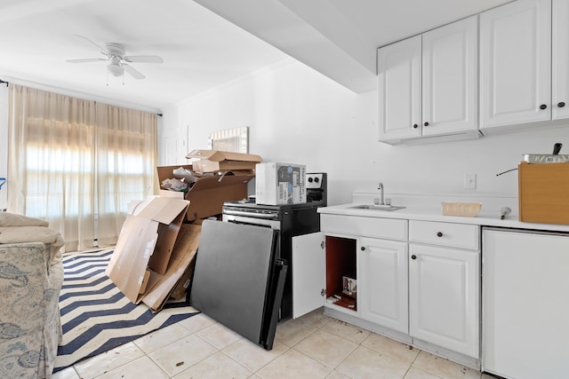 kitchen featuring ceiling fan, light tile patterned flooring, white cabinetry, and sink