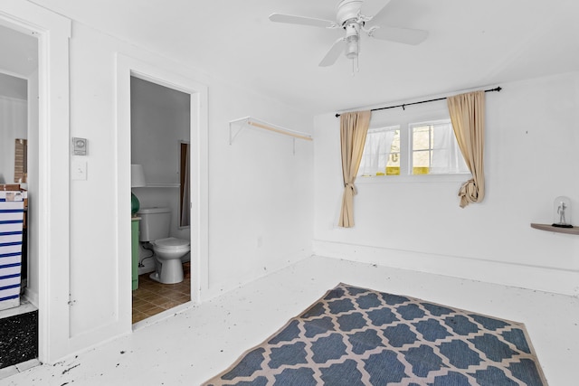 interior space featuring toilet and ceiling fan