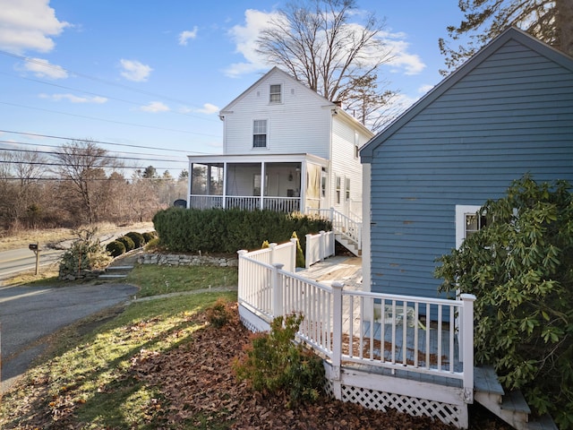 back of house with a sunroom