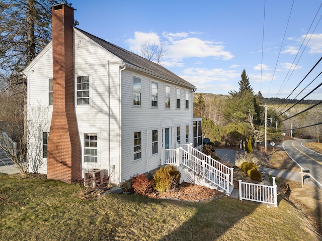 rear view of property featuring a yard