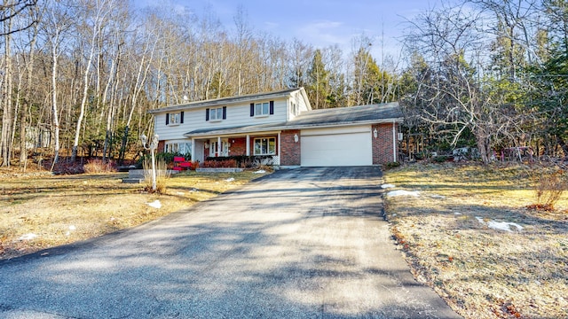 view of front property with covered porch and a garage