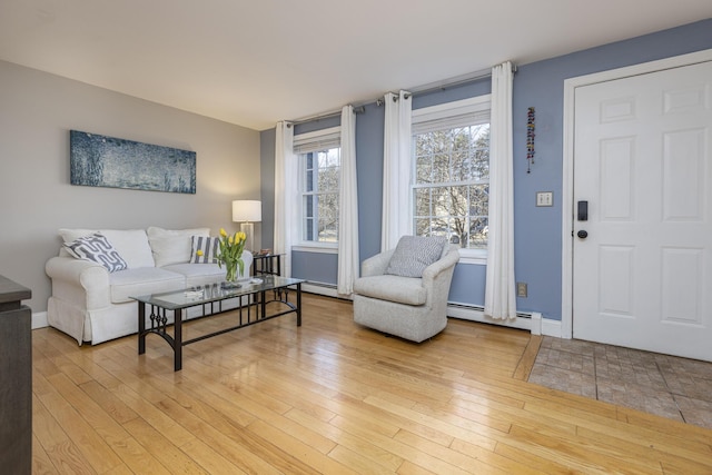 living room with a baseboard radiator and hardwood / wood-style flooring