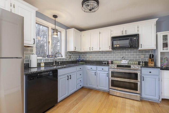 kitchen with white cabinetry, sink, black appliances, and light wood-type flooring