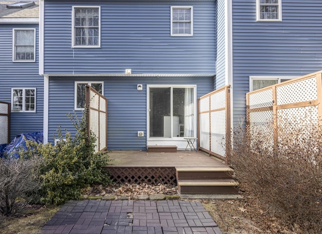 rear view of house with a wooden deck