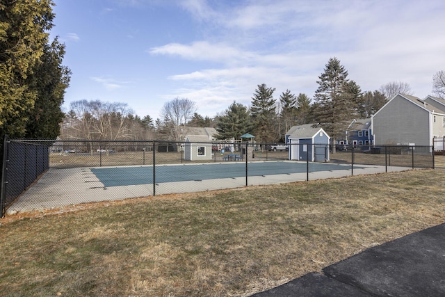 view of swimming pool featuring a playground, a yard, and a storage unit