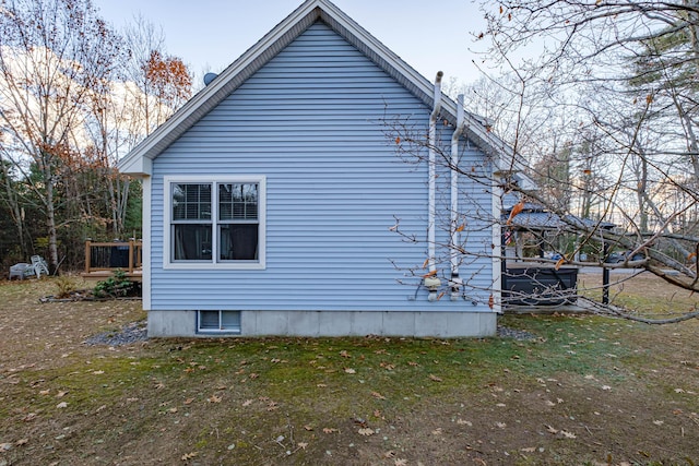 view of side of home with a yard