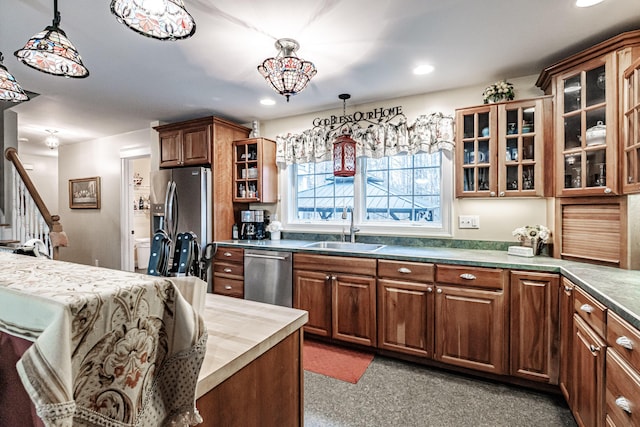 kitchen featuring sink, hanging light fixtures, and stainless steel appliances