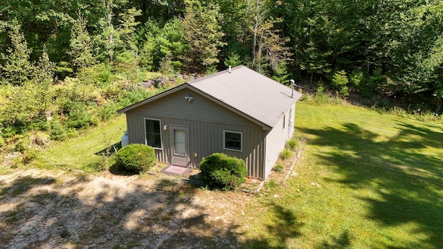 rear view of property with a yard