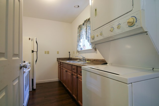 kitchen featuring stove, dark wood-type flooring, stacked washer and clothes dryer, and sink