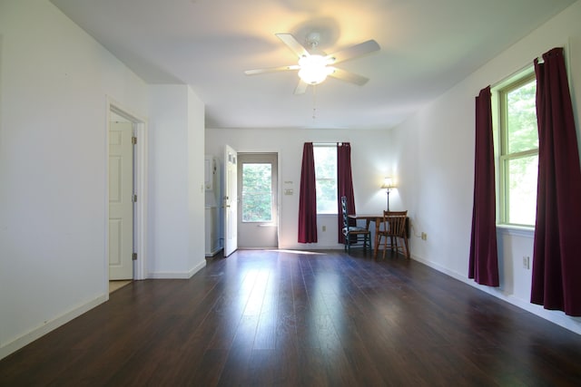 unfurnished room featuring ceiling fan and dark wood-type flooring