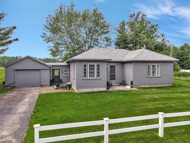 ranch-style home with a front yard and a garage